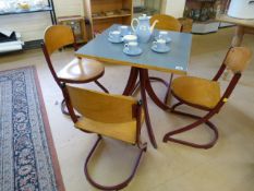 Retro French table and four chairs in wood and burgendy coloured metal by Souvignet Plichaise