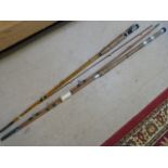 Two Antique cane fishing rods with cork handles