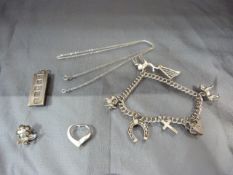 Silver items to include ingot, charms on a bracelet etc...