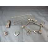 Silver items to include ingot, charms on a bracelet etc...