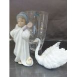 Three Lladro figures - to include Baby in a manger, Bundled Bather, Male swan and a boxed Durand