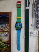 Swatch Wall clock in the form of a Wristwatch - in blue, green, red and yellow. Working order and