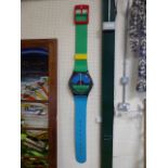 Swatch Wall clock in the form of a Wristwatch - in blue, green, red and yellow. Working order and