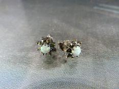 Pair of hallmarked silver earrings with central opal and marcasite outer ring in the form of a star