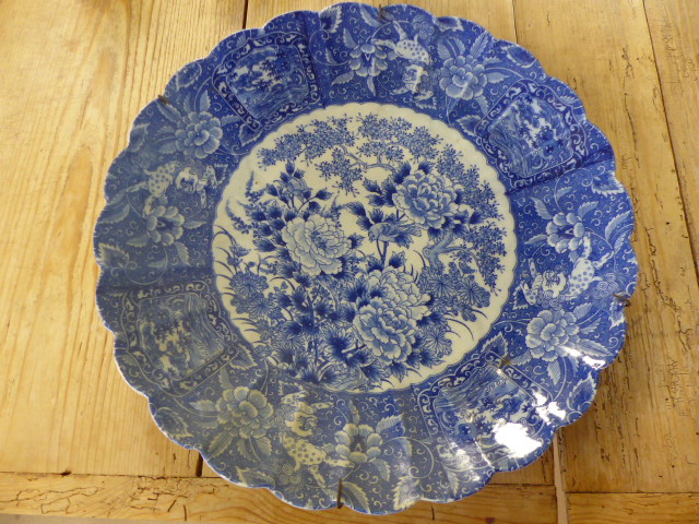 Large blue and white possibly oriental charger. To the centre a large floral motif with trees and