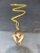 9ct Bright yellow gold chain with a 9ct Rose Gold Locket A/F Approx weight - 4.3g