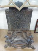 Large and ornate Cast iron fire place decorated to the centre with putti and an outer foliate