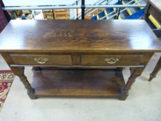Mahogany hall table with two drawers with loop handles. Below is a single shelf.