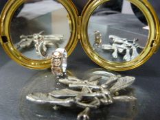 Unmarked silver coloured dress ring along with a white metal brooch in the form of Sycamore seeds