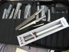 Set of cased Global Chef's Knives in fitted case along with a new in box balanced sharpener.