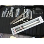 Set of cased Global Chef's Knives in fitted case along with a new in box balanced sharpener.