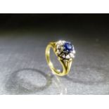 A Steel and Dolphin 70's poss 9ct (hallmark rubbed) Sapphire and Diamond flower design ring.