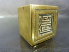 Brass oriental seal in the form of a cube, one side carved to form the stamp/seal.