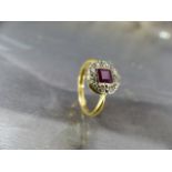 18ct Art Deco diamond and Ruby ring. The hexagonal platinum setting with central square cut bright