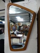 1970's Danish Teak wood wall mirror of shaped form having Denmark impressed to verso.