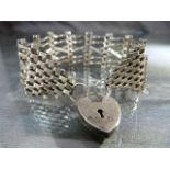 Pretty six bar gate bracelet with unusual 'cross-over' gates. Heart shaped padlock with safety chain