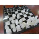 Clear Agate and possibly Onyx chess set. Complete with two spare white pawns. Damage to the queen on
