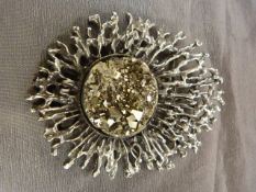 SIlver metal pendant/Brooch by an unknown designer. At its heart is an approx: 30mm Disk of