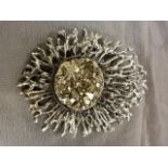 SIlver metal pendant/Brooch by an unknown designer. At its heart is an approx: 30mm Disk of