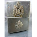 Two silver metal Military issue match box holder - 1 with plaque for Devonshire Regiment and the