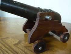 Bronze table cannon on later wooden stand with wheels