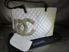 Coco Chanel style white leather shoulder bag, orange interior with Snakeskin effect logo to front '