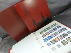 Two various stamp albums containing loose and stickered stamps along with an album for the 1980