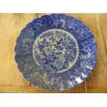 Large blue and white possibly oriental charger. To the centre a large floral motif with trees and