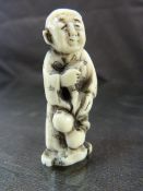 JAPANESE IVORY NETSUKE. Carved and worked ivory pendant typically worn on a kimono of an aged