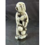 JAPANESE IVORY NETSUKE. Carved and worked ivory pendant typically worn on a kimono of an aged