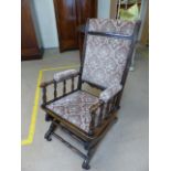 Antique oak rocking chair with gliding action - Upholstered to back and seat.