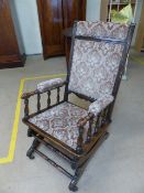 Antique oak rocking chair with gliding action - Upholstered to back and seat.