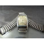 Vintage Bulova watch with shaped square dial. Gold coloured numerals with subsidiary face. Stainless