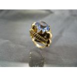 Gold faux Zircon ring, Centre Blue paste Zircon approx: 10mm diameter set into an American ‘Tank’