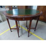 Oval mahogany antique occasional table with green toolwork leather inlay. Carved to outer top of