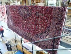 Large red ground carpet with all over pattern and floral border 356 x 270