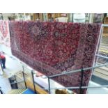 Large red ground carpet with all over pattern and floral border 356 x 270