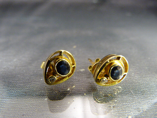 Pair of 18ct Gold earrings set with a single sapphire and Diamond -