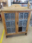 Leaded glass fronted light oak cabinet with beaded decoration around the frieze. (missing one