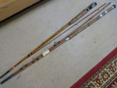 Two Antique cane fishing rods with cork handles