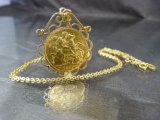 1909 Full sovereign in an 18ct mount and chain Total approx weight - 13g