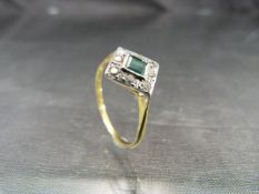 18ct Gold Art Deco ring with central Emerald stone surrounded by eight diamonds