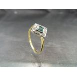 18ct Gold Art Deco ring with central Emerald stone surrounded by eight diamonds