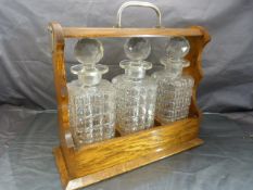 Oak cased Tantalus with three matching decanters. Monogrammed to lock F & WG