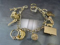 9ct Gold Charm bracelet and fifteen charms to include: a church that opens to reveal a wedding;