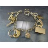 9ct Gold Charm bracelet and fifteen charms to include: a church that opens to reveal a wedding;