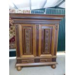 Carved Oak and Mahogany linen type press of two cupboards and two drawers under. The doors having