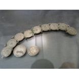 A white metal bracelet set with 9 three pence coins. The earliest 1931, with additional three