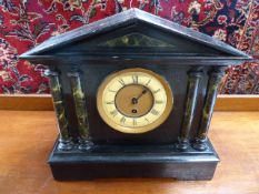 Antique wooden lacquered mantle clock of Architectural form. The Pillars of marbled design with an