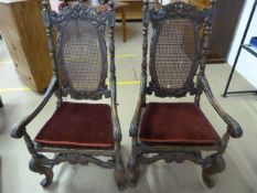 Good Example of a Pair of Carolean open arm chairman style chairs. The highly carved chair has a